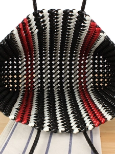 Vertical striped woven tote bag in black, white, and red with sturdy braided handles