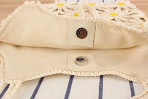 Close-up of crochet tote bag showing interior lining and metal magnetic closure