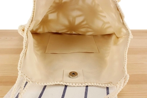 Detail view of handmade woven bag with magnetic snap closure and inner pocket lining