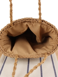 Handwoven straw tote bag with fabric lining and top handles for summer vacation beach trips