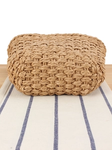 Handmade woven handbag on a striped runner, perfect for summer vacation and daily use