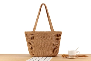 Close-up of khaki handmade crochet tote bag featuring tight weaving and hollow mesh detail