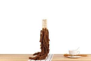 Detailed macro view of bohemian hand-woven curtain tiebacks with wood beads and brown tassels