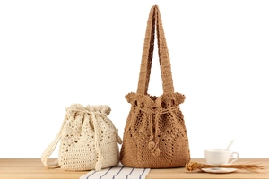 Detailed macro view showing intricate hollow-out texture of handmade woven drawstring bags