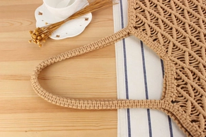 Close-up of geometric hollow pattern and woven knots on cotton rope bohemian tote