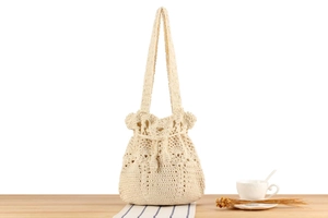 Handcrafted crochet drawstring tote bag in off-white with vintage hollow weave design