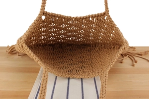 Close-up of bohemian cotton rope woven bag showing interior texture and long side tassels