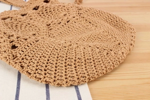 Close-up of handmade crochet handbag showing intricate woven texture and natural fiber detail