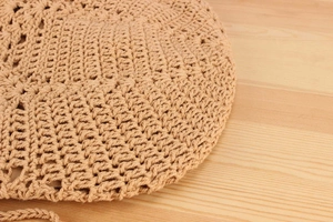 Macro texture of handmade woven paper rope bag with intricate crochet pattern details