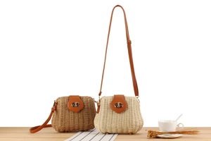 Detail of handmade woven crossbody bags with leather flap and gold twist lock closure