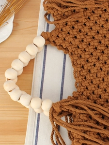 Handmade woven cotton rope bag in caramel brown with decorative wood bead handles