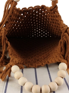 Brown macramé woven handbag with white wooden bead handles and side fringe tassels