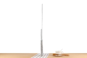 Side view of silver metallic crochet bag showing the ultra-slim profile on wooden surface