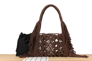 Detail of dark brown handwoven tote bag featuring bohemian tassels and a secure inner pouch