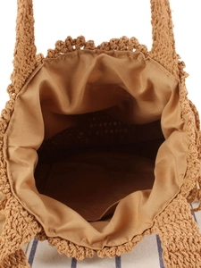 Handmade woven straw tote bag with natural earth tones and fabric lining for vacation use