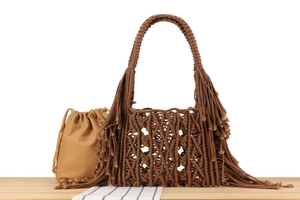 Detail of bohemian hand-woven tote bag with long fringes and cotton canvas inner pouch