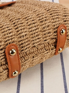 Handmade woven crossbody bag with brown leather straps and gold metal rivets detailing