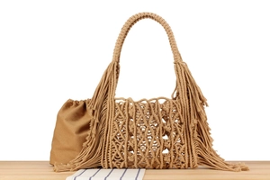 Close-up of bohemian woven bag with fringe detailing and cotton drawstring liner