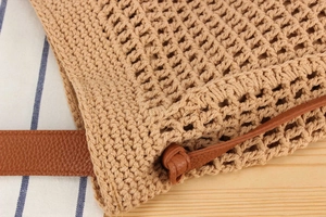 Detail of hand-woven cotton mesh bag with premium lychee grain leather shoulder strap