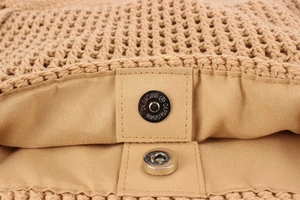Detailed close-up of woven cotton rope bag with magnetic metal clasp and inner lining