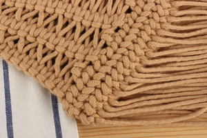 Macro detail of hand-woven macrame cotton bag with elegant long tassels for women