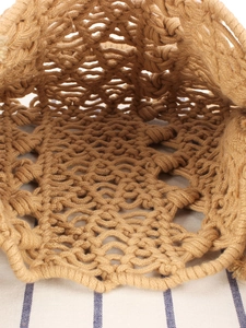 Detailed internal view of a handmade woven tote bag with intricate bohemian knot patterns