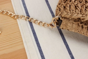 Detail of crochet woven bag with detachable golden metal chain and lobster clasp