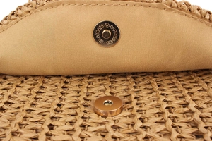 Detail of the golden magnetic closure and canvas lining on a handwoven crochet bag