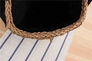 Detail of woven straw bag opening showing durable edge and black canvas lining texture
