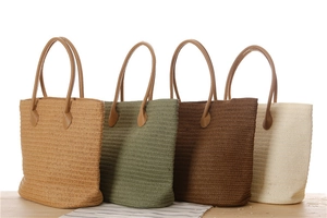 Detailed close-up of woven paper rope tote bags in four natural earth tone colors