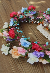 Detail of colorful fabric flower crown with berries and rustic vine style headband