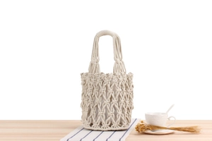 Detail view of beige bohemian crochet tote bag with woven mesh pattern and inner pouch
