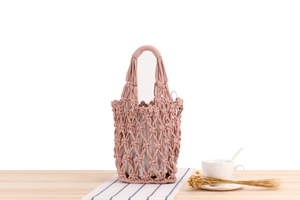 Detail of vintage handwoven cotton mesh tote bag in dusty pink with drawstring liner