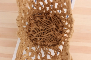 Top view of the spacious interior and hollow macrame weave detail of this cotton rope bag