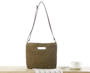 Detailed texture of dark brown woven paper rope bag on a wooden table with home decor