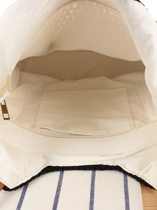 Minimalist canvas tote bag featuring secure zipper closure and interior storage pocket