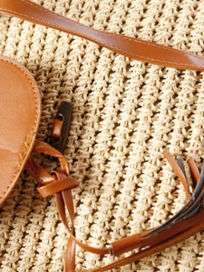 Chic beige woven paper rope shoulder bag with brown leather strap and tassel detail