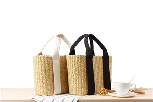 Detailed texture of handcrafted woven straw handbags in beige and black variants