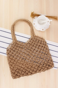Detailed close-up of handmade hollow mesh paper rope woven tote bag with circular patterns