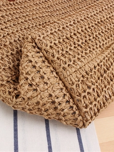 Minimalist woven straw shoulder bag with handcrafted texture for beach and daily commute