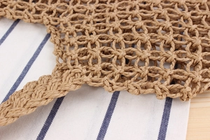 Detailed macro view of handcrafted paper rope woven mesh bag showing intricate hollow patterns