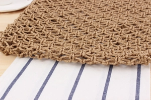 Close-up of natural paper rope woven pattern with hollow mesh texture on a tote bag