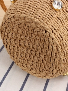 Woven bucket bag with large crystals and natural wood color for beach holidays