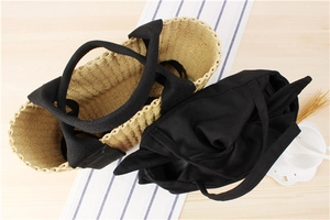 Top view of woven straw tote bags showing interior structure and canvas handles detail