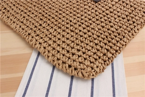 Macro shot of natural brown paper rope weaving texture on a minimalist shoulder bag