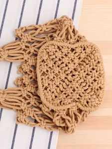 Handmade bohemian hollow macrame tote bag crafted from natural brown cotton weave