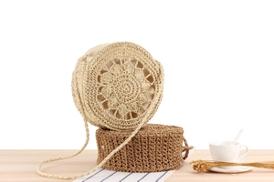 Close-up of hollow round woven straw bags with detailed radial patterns and inner lining