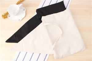 Flat lay of minimalist black and beige woven cotton fabric bags on a wooden table