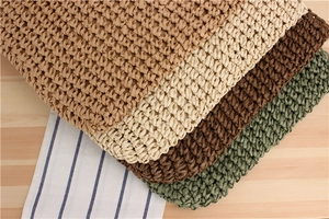 Macro detail of natural straw woven texture in khaki, cream, brown and dark green