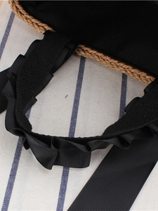 Straw woven tote bag with black ruffled ribbon handles and soft inner lining